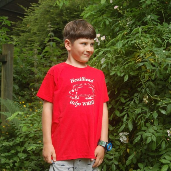 A young boy modelling a red Hessilhead Wildlife Trust t-shirt