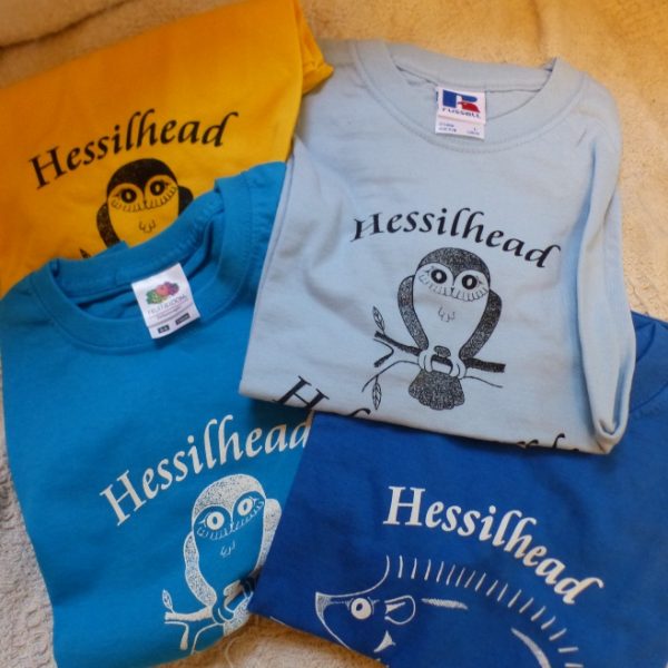 Four Hessilhead Wildlife Trust t-shirts folded and in different colour options
